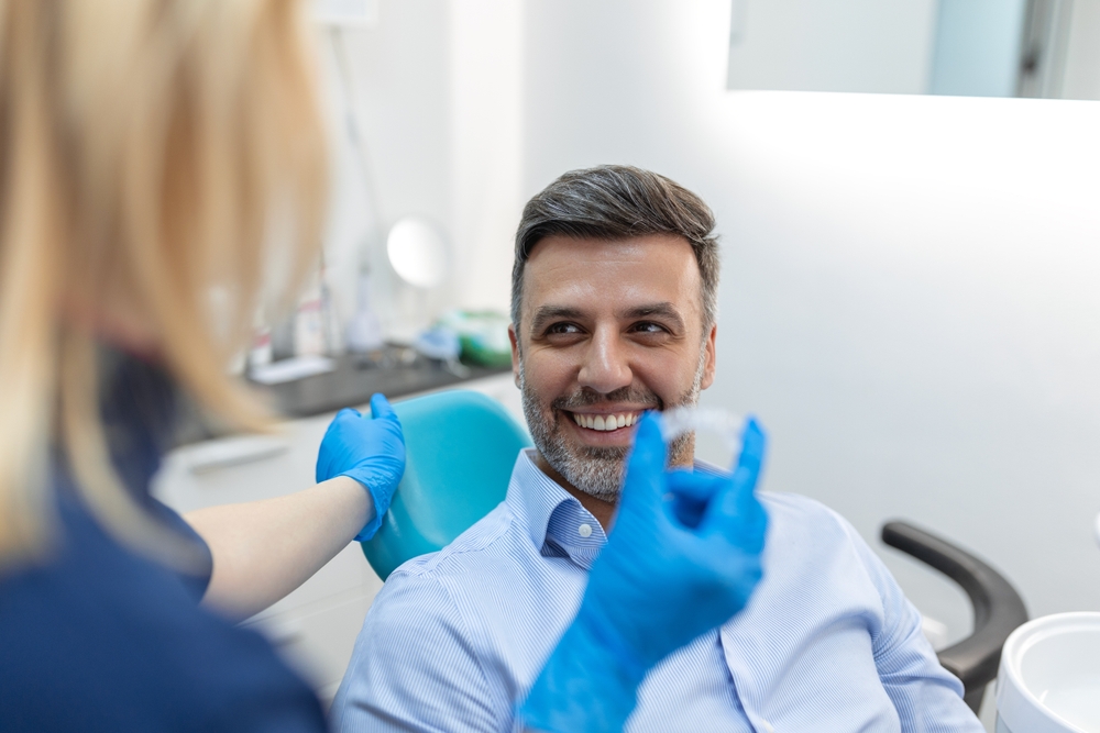 young man at the dentist getting Invisalign