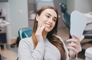 young woman looking at her smile