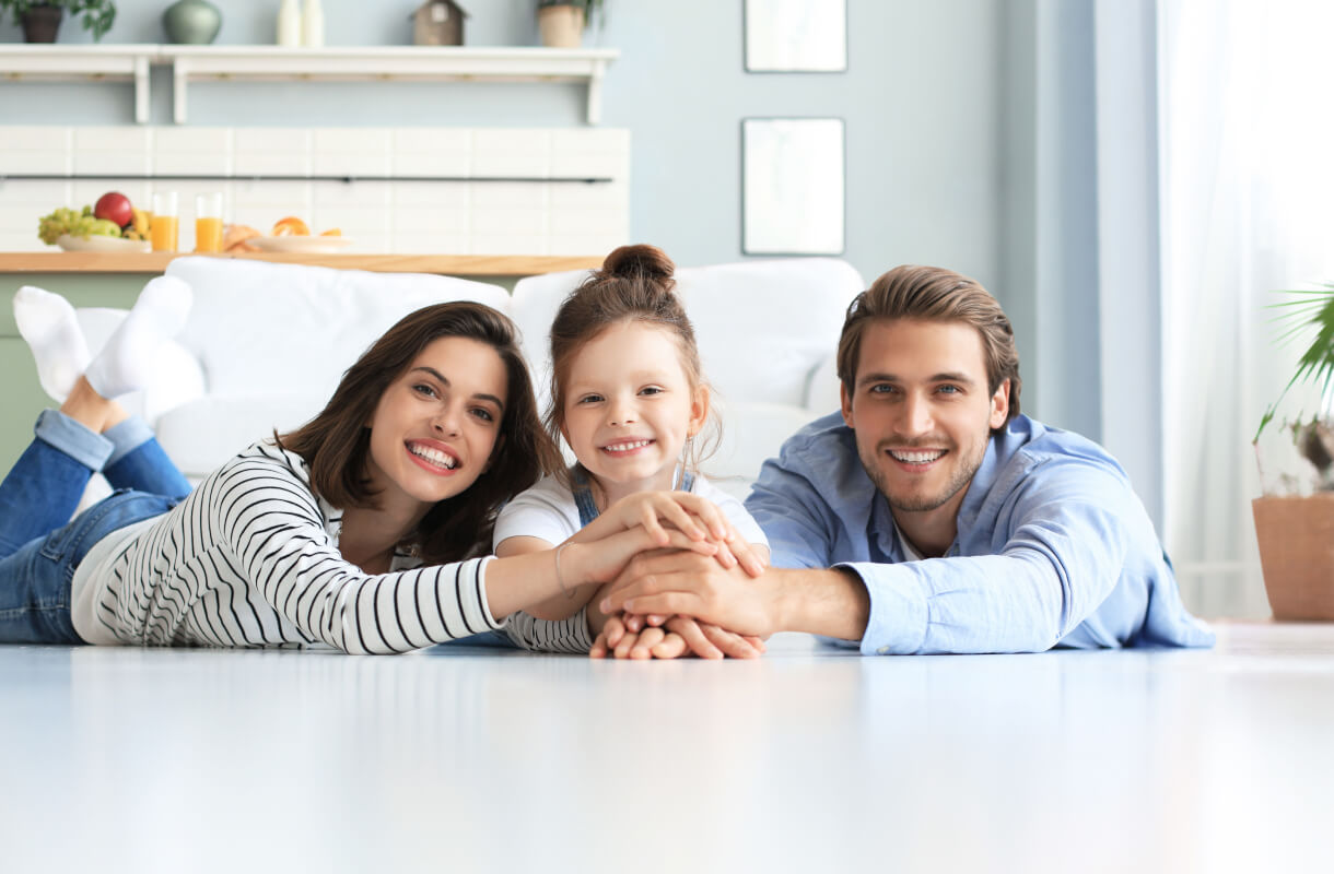 family of three smiling togeter